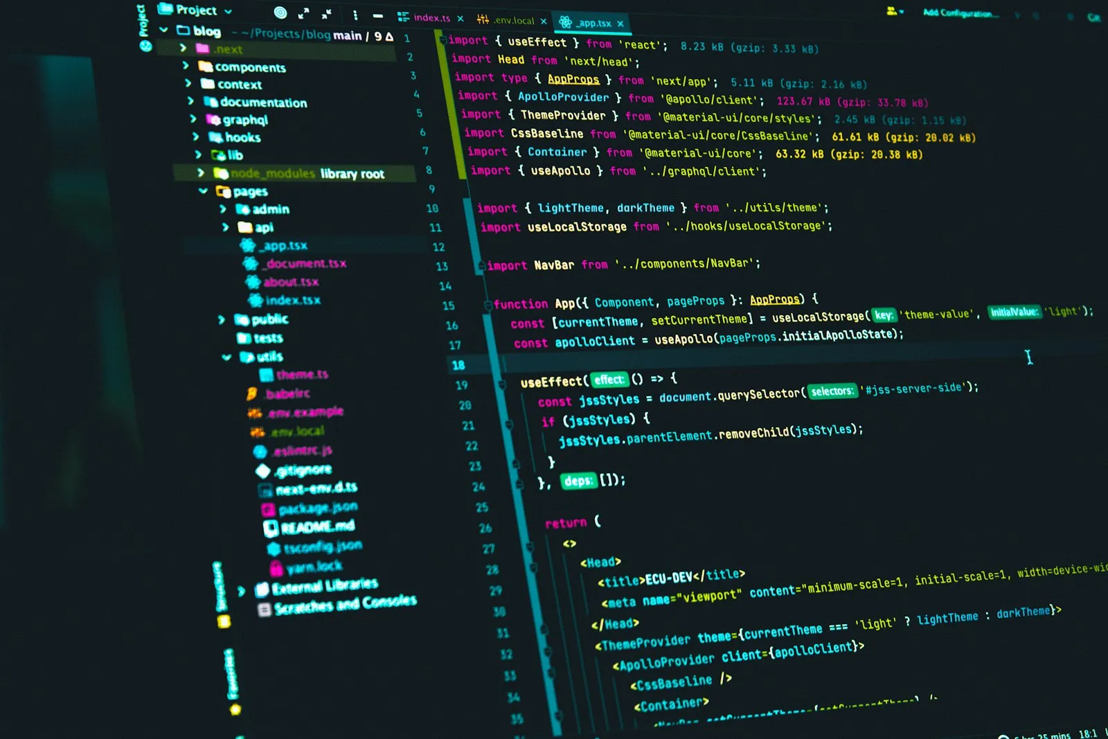 Code editor displaying React source code on a monitor