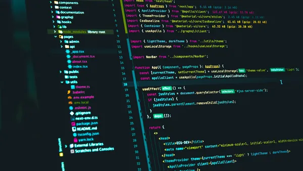 Code editor displaying React source code on a monitor