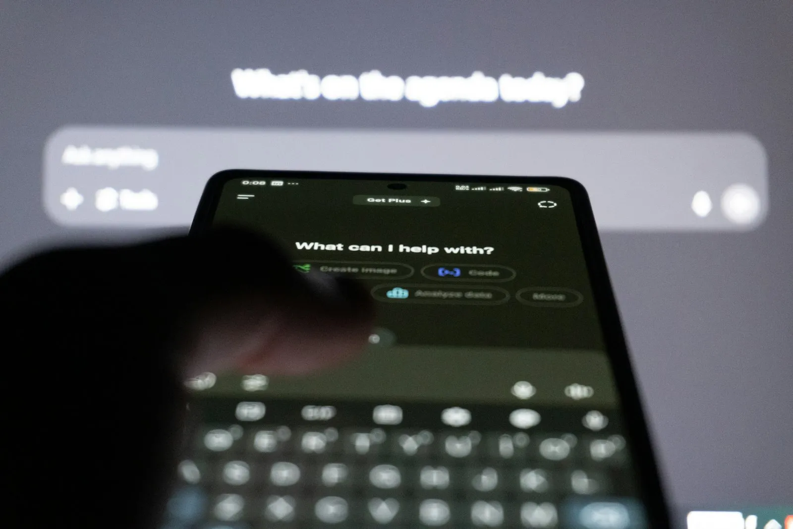 Person typing on a smartphone with an AI chat assistant on screen