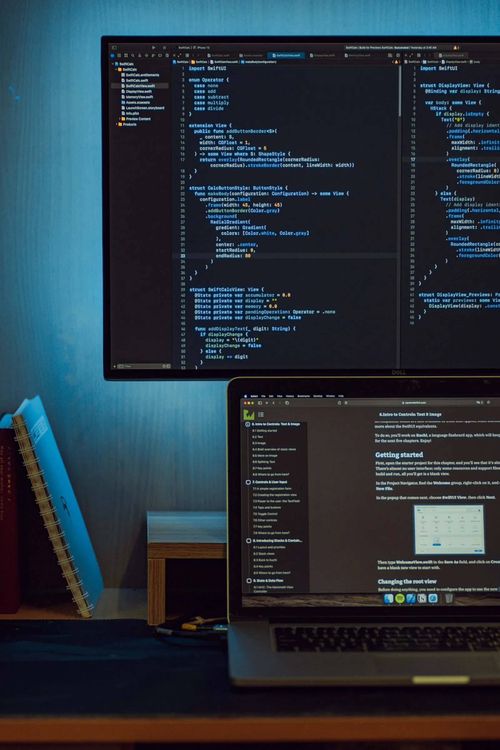 Monitor and laptop displaying code and a programming tutorial