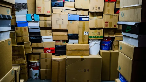 A room filled with many stacked cardboard boxes