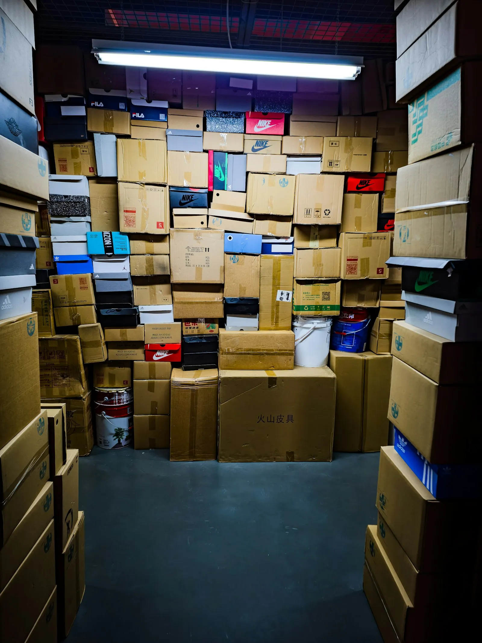 A room filled with many stacked cardboard boxes