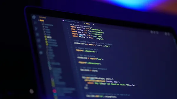 Laptop screen displaying colorful lines of code